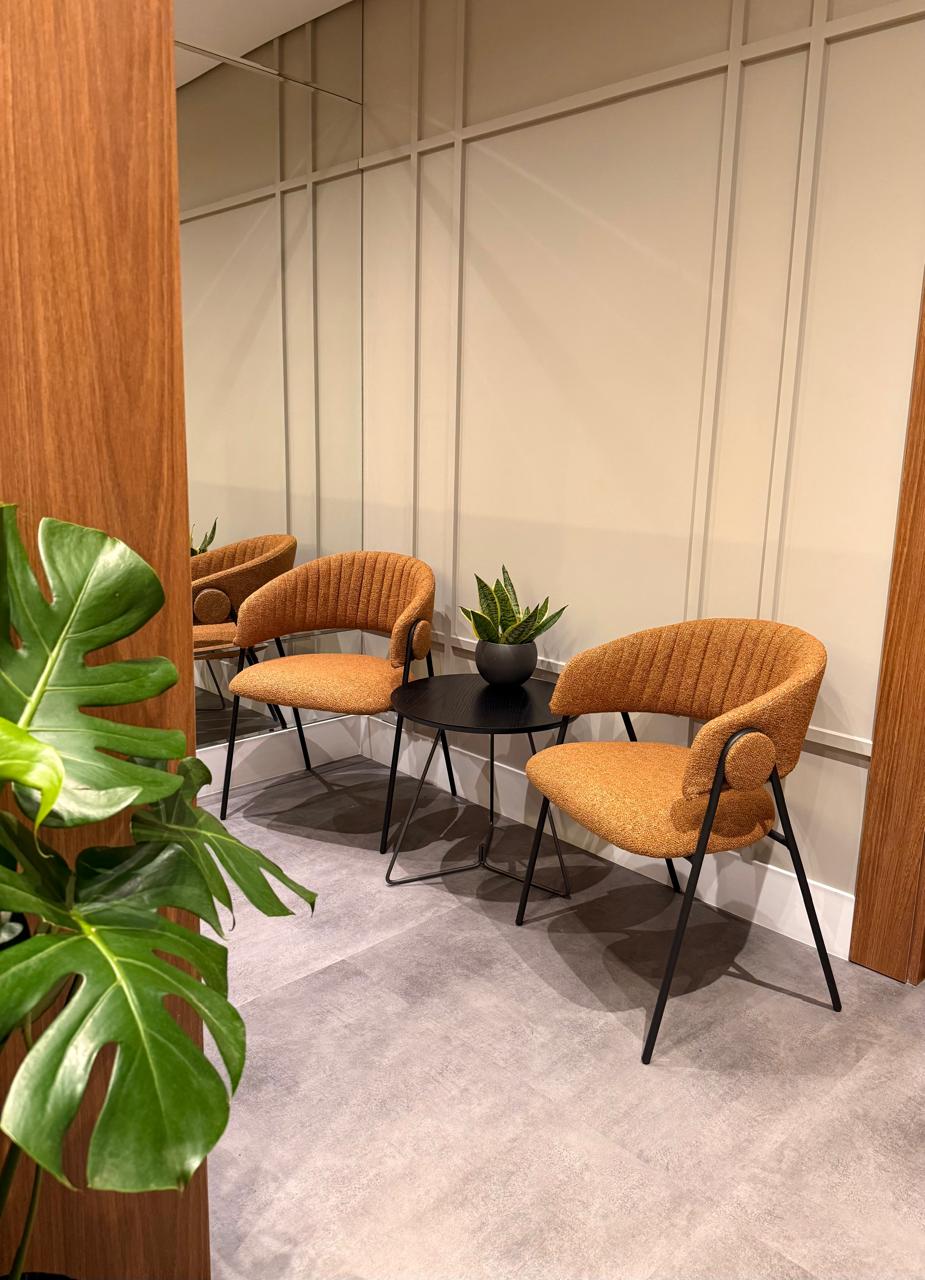 Sala de espera do consultório, com poltronas e plantas